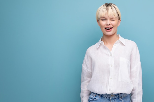 Young pretty caucasian blond career woman in white blouse isolated on blue background with copy