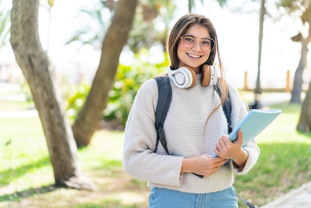 Young pretty caucasian woman holding a notebook