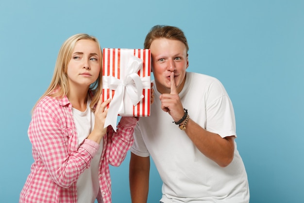 Young pretty couple two friends guy and woman in white pink t-shirts posing 