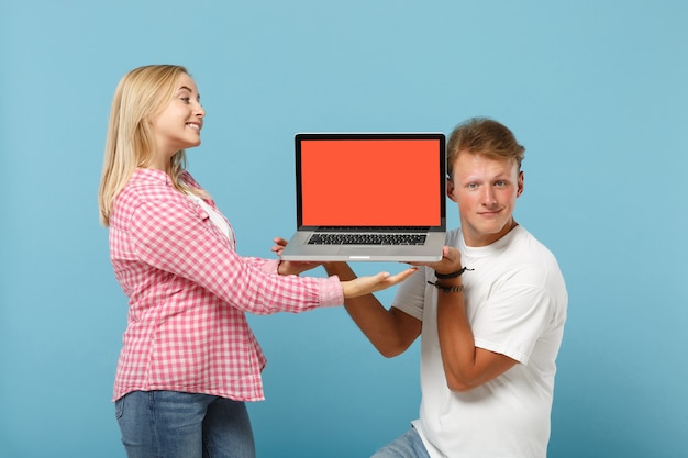 Young pretty couple two friends man and woman  in white pink t-shirts posing 