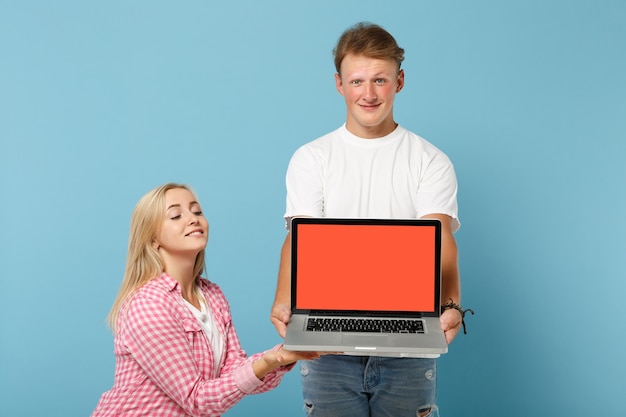 Young pretty couple two friends man and woman  in white pink t-shirts posing 