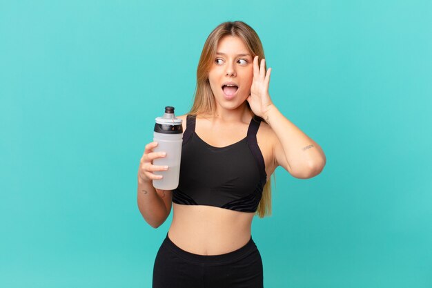 Young pretty fitness woman feeling happy, excited and surprised