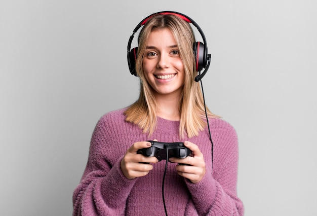 Young pretty gamer woman with headset and a controller