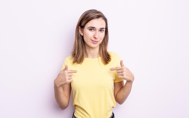 Young pretty girl looking proud, positive and casual pointing to chest with both hands