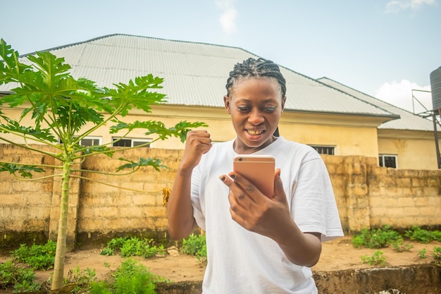 Photo a young pretty girl on white shirt using her phone to make video call pointing into her phone excitement happiness happy face