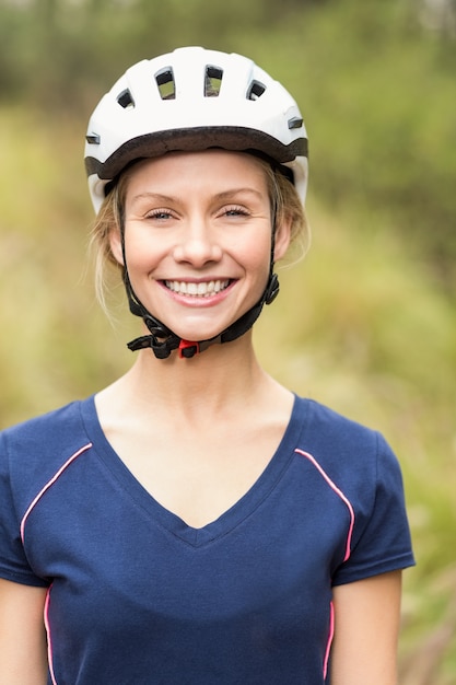 Young pretty happy biker looking at camera