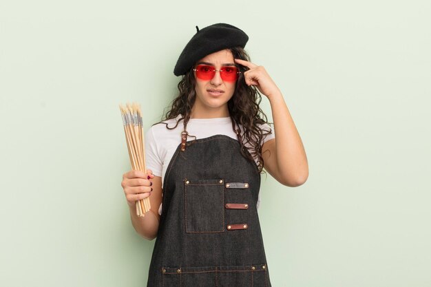 young pretty hispanic woman feeling confused and puzzled, showing you are insane. artist concept