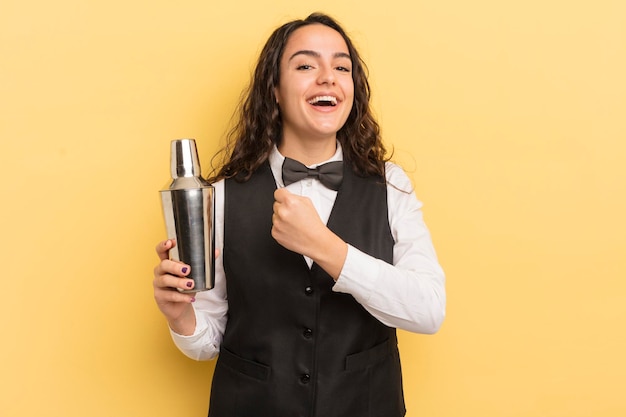 Young pretty hispanic woman feeling happy and facing a challenge or celebrating bartender and cocktail concept