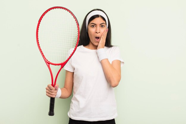 Young pretty hispanic woman feeling shocked and scared tennis concept