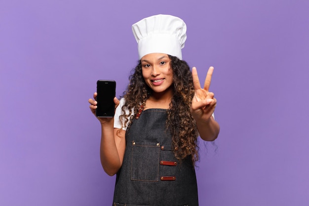 Young pretty hispanic woman happily and proud chef concept