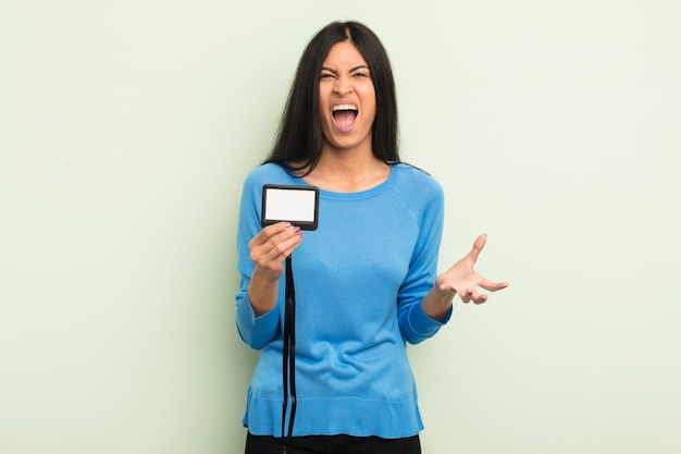 Young pretty hispanic woman looking angry annoyed and frustrated accreditation pass id concept