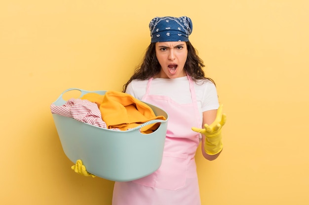 Young pretty hispanic woman looking angry annoyed and frustrated wash and clothes concept