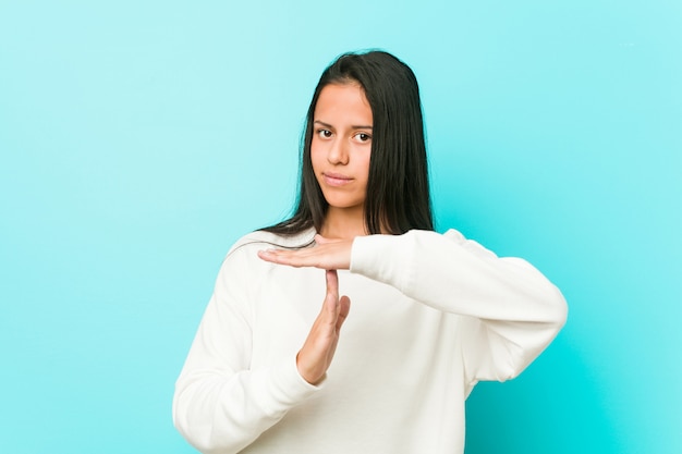 Young pretty hispanic woman showing a timeout gesture.