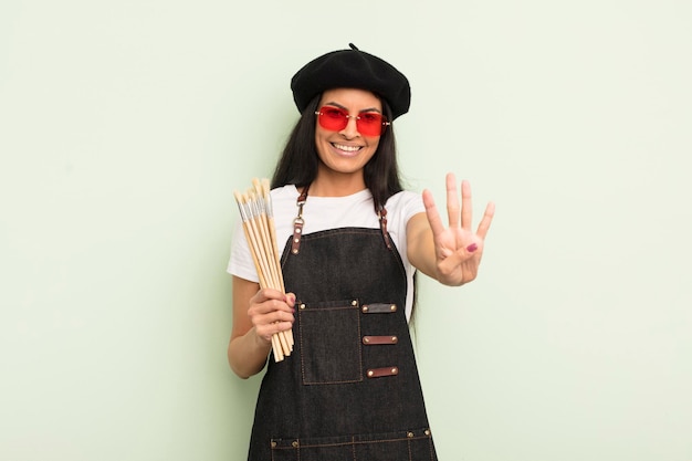 Young pretty hispanic woman smiling and looking friendly showing number four art student concept