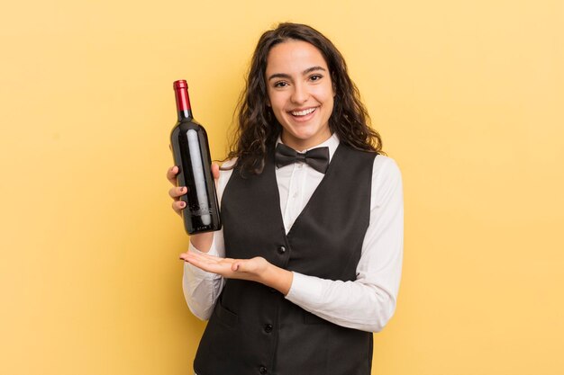 Young pretty hispanic woman waiter with a bottle of wine