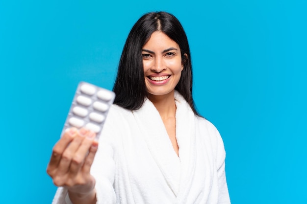 Young pretty hispanic woman with pills tablet. illness concept