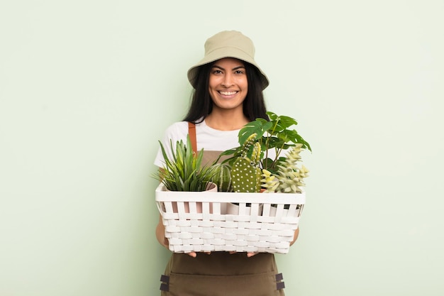 Young pretty hispanic woman with plants farmer or gardener concept