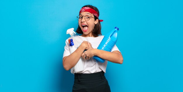 Young pretty housekeeper woman with clean products