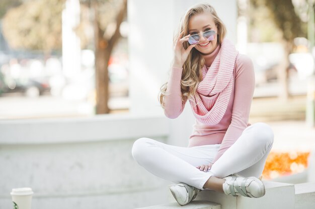 Young pretty lady outdoor. Woman at urban background. Beautiful female model.