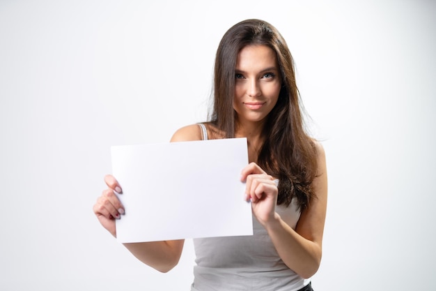 Young pretty lady with white paper Beautiful girl woman showing thumbs up sign