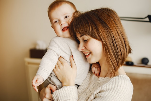 young and pretty mother playing with her son at home