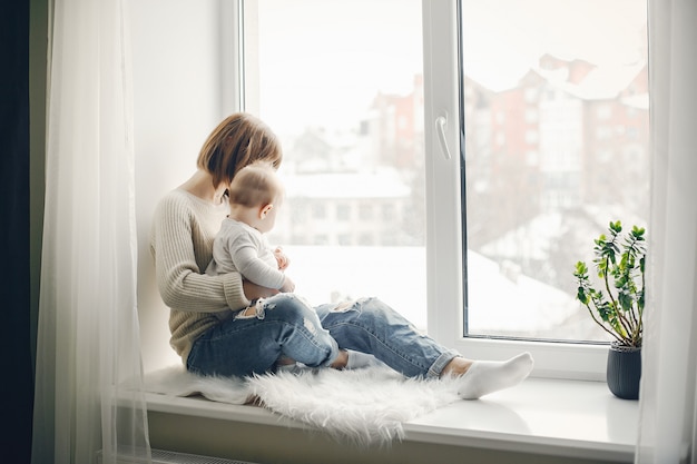 young and pretty mother playing with her son at home