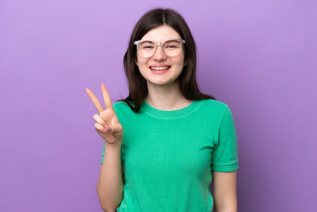 Young pretty Russian woman isolated on purple background With glasses and doing OK sign