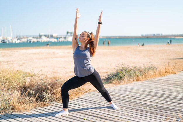 Young pretty sport woman doing yoga