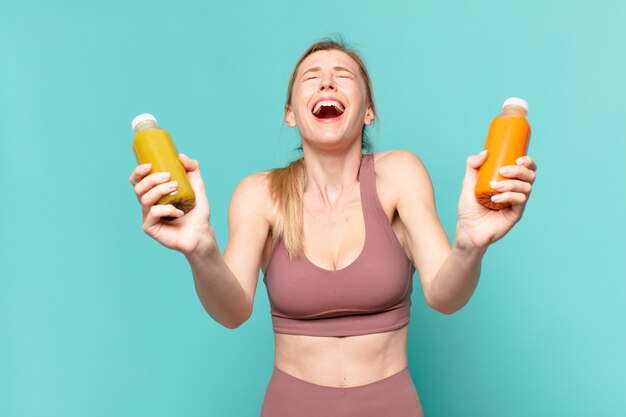 Young pretty sport woman with happy expression and holding a smoothy