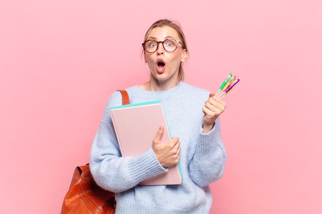 Young pretty student woman surprised expression