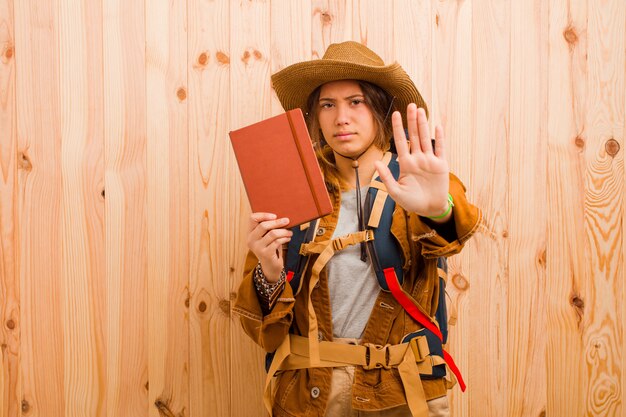 Young pretty traveler woman with a diary