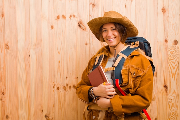 Young pretty traveler woman with a diary