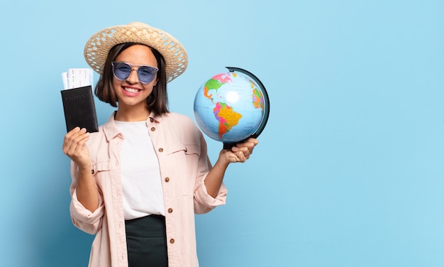 Young pretty traveler woman with a world globe map. travel or holidays concept