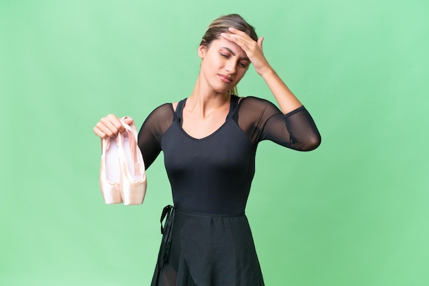 Young pretty Uruguayan woman practicing ballet over isolated background with headache