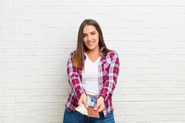 Young pretty woman  against brick wall texture