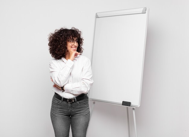 Young pretty woman against isolated background