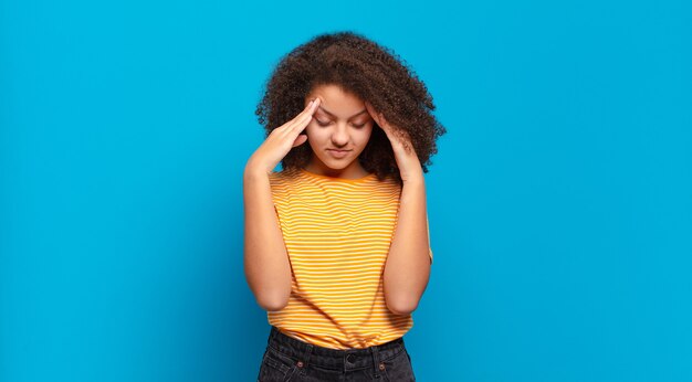 young pretty woman against isolated wall