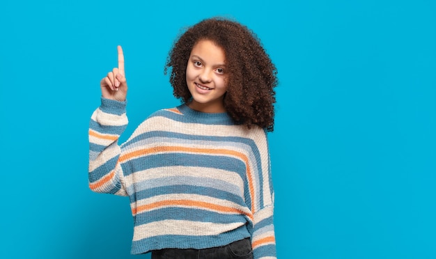 young pretty woman against isolated wall