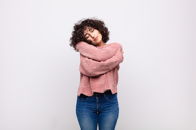 young pretty woman against isolated wall