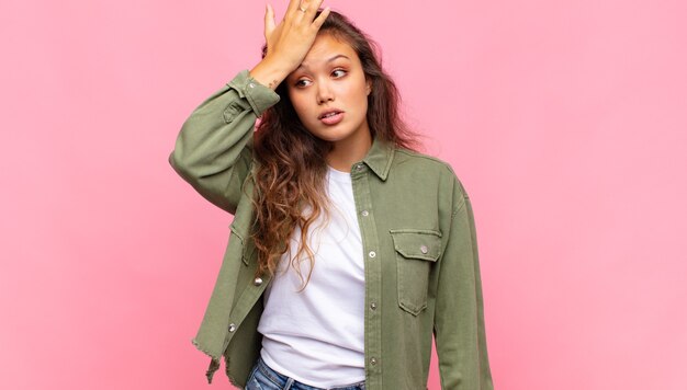 young pretty woman against isolated wall