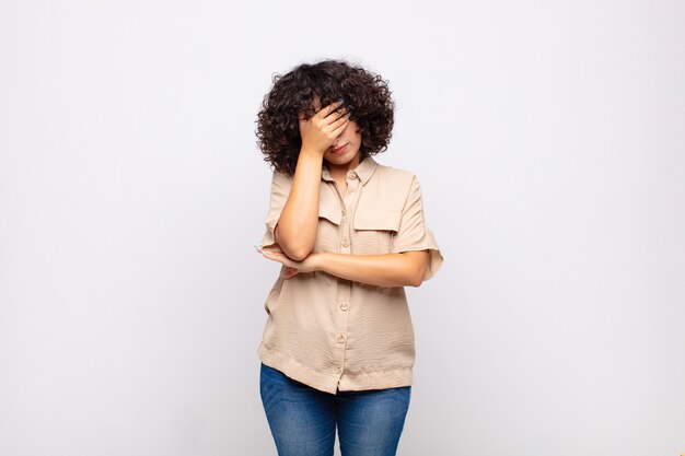 young pretty woman against isolated wall