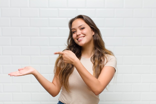 young pretty woman against white wall