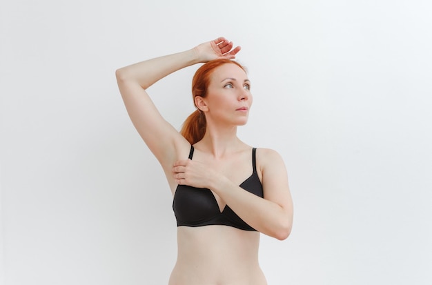 A young pretty woman in a black bra Stunning girl in underwear. Breast health body positive