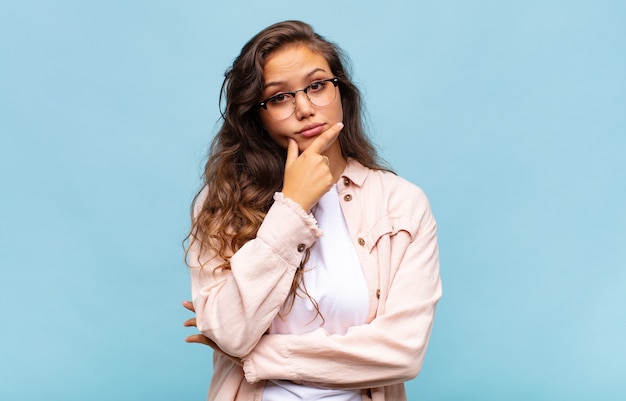 Young pretty woman on blue background