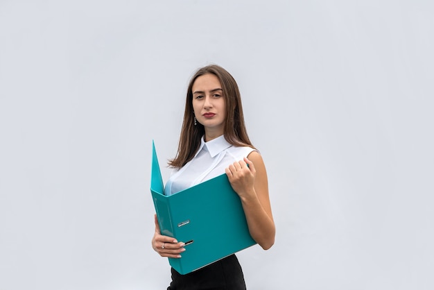 Young pretty woman in business clothes with paper folder, isolated on white background. Concept of job