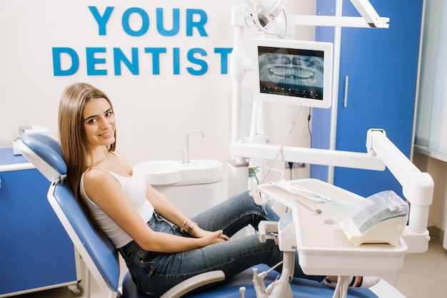 Young pretty woman in dentist chair waiting for treatment