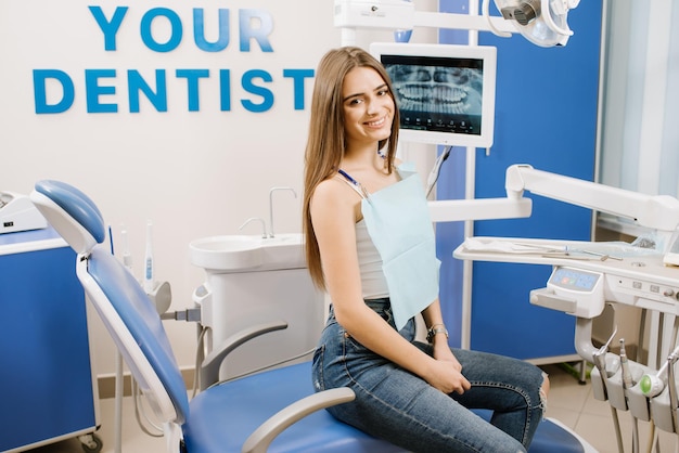 Young pretty woman in dentist chair waiting for treatment