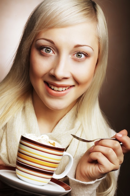 Young pretty woman drinking coffee