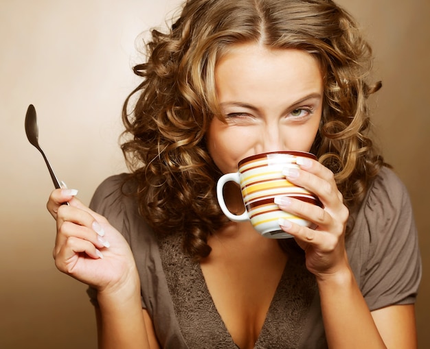 Young pretty woman drinking coffee