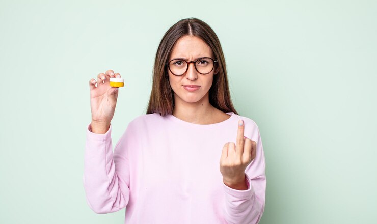 फोटो young pretty woman feeling angry, annoyed, rebellious and aggressive. contact lenses concept